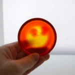 René Lalique — An exclusive and rare orange ‘Deux Zephyrs’ by Lalique — detail 1